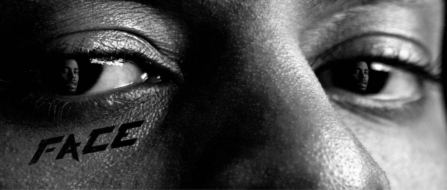 Close-up of a person's face with the word 'FACE' tattooed on their cheek.